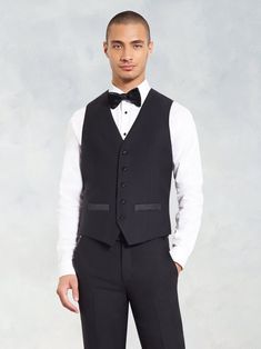 Designed to be worn with any of our black tuxedos, this vest has you covered - from layered under a jacket, to boogie-ing without one on the dance floor. 100% super-fine Italian merino wool Five-button closure Full backing Black satin accents Formal Winter Sleeveless Vest, Formal Sleeveless Winter Vest, Elegant Winter Blazer With Vest, Black Tailored Sleeveless Suit, Classic Formal Winter Vest, Elegant Winter Vest, Formal Fitted Three-piece Suit With Vest, Black Sleeveless Suit With Vest, Black Fitted Vest For Semi-formal Occasions