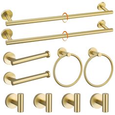 an assortment of brass bathroom accessories including towel rings, toilet paper holders and door handles