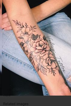 a woman's arm with flowers on it