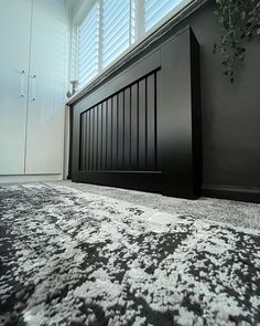 a black and white bedroom with an area rug that looks like it has snow on the floor