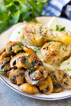 chicken, mushrooms and mashed potatoes on a plate