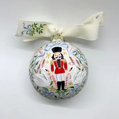 an ornament with a painting of a man in uniform on it's side