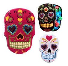 three colorful sugar skulls with hearts on them