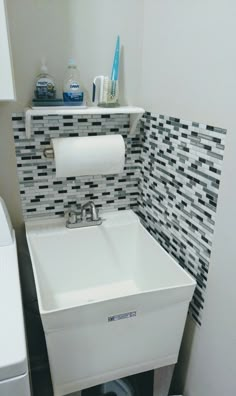 a white sink sitting next to a toilet in a bathroom