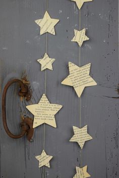 some paper stars hanging from a hook on a door with words written on them and an old rusted horseshoe