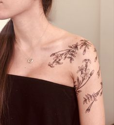 a woman with a flower tattoo on her shoulder