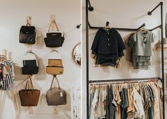 there are many handbags and purses hanging on the wall next to each other