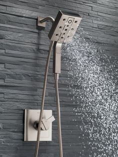 thermostaer with shower head and handset, in beige color on brick wall