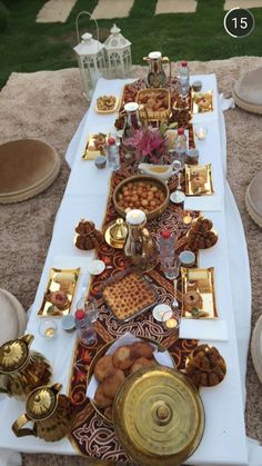 a table set up with plates, cups and other items on it for a party