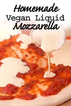 homemade vegan liquid mozzarella sauce being poured on top of a pizza