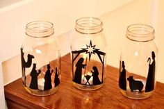 three glass jars with nativity images on them