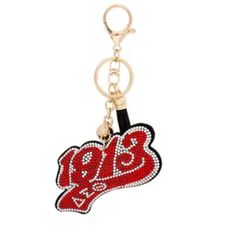 a red and black keychain with the word bling on it's side