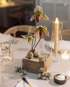 the table is set with flowers and candles