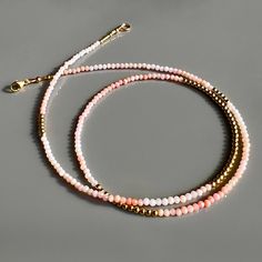 A luxurious, faceted pink opal & 14K gold beaded strand necklace with a lobster clasp provides an elegant, subtle hint of style. Wear it solo for a graceful look or layer it for a unique, trend-setting vibe. Beaded necklace with faceted pink opal gemstones 14K yellow gold beads + findings Lobster clasp closure shipping : allow up to a week from date your order was placed for shipping Single Strand Pink Opal Necklace With Round Beads, Gold Gemstone Necklace, Pink Opal, Bead Strand, Strand Necklace, Opal Gemstone, Gold Beads, Gemstone Necklace, Lobster Clasp