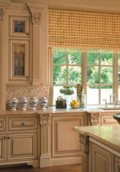 a large kitchen with an island in the middle and lots of cabinets on both sides