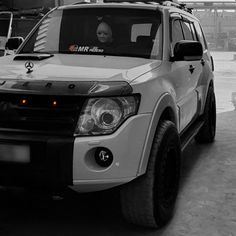 a white truck parked in front of a building