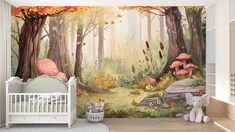 a baby's room with a forest wall mural