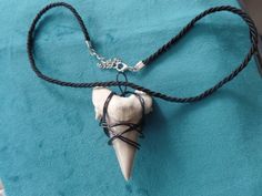 a necklace with an animal's skull on it and a cord attached to it