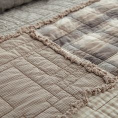 a close up view of a quilt on a bed