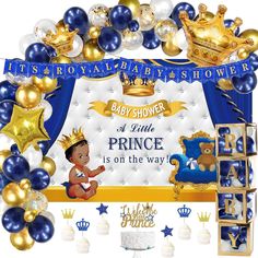 a baby shower is decorated with blue and gold balloons, crowns, and other decorations