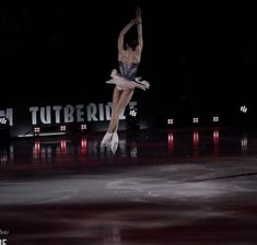 a female figure skating on an ice rink