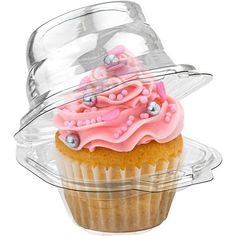 a cupcake with pink frosting and sprinkles in a plastic container