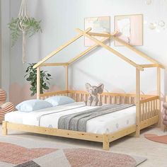 a child's bed with a wooden frame and canopy over it, in a white room