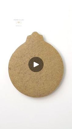 a cork coaster with a video play button on it