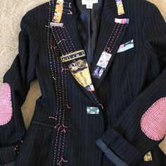 a black suit with pink patches on it