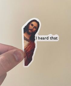 someone holding up a sticker with the image of jesus on it that says, i heard that