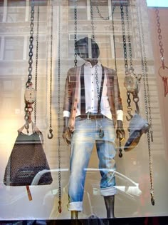 a mannequin dressed in jeans and shirt with chains hanging from it's sides