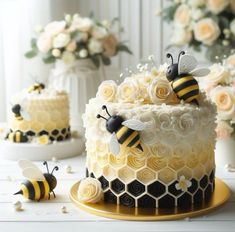 there are two bees on top of the cake and one is white with yellow frosting