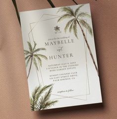 a wedding card with palm trees on it