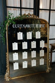 a gold framed mirror with notes attached to the front and back of it that says our favorite people