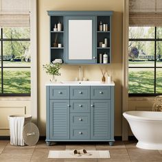 a bathroom with blue cabinets and a white bathtub