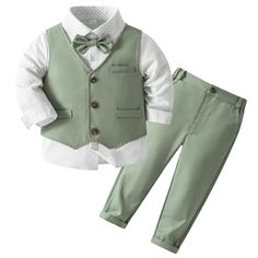 a little boy in a green suit and bow tie is standing next to his pants