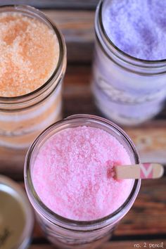 three jars filled with different colored powders