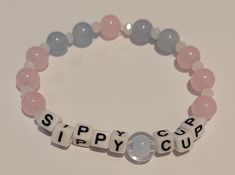 a bracelet with the word sippy cup spelled in small letters on top of it