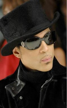 a man wearing sunglasses and a black hat