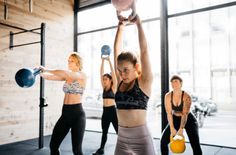 a group of women doing exercises with kettles