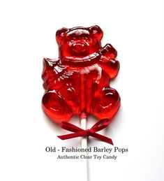 a red gummy bear lollipop on a stick