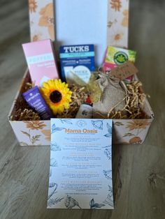 a box filled with lots of goodies on top of a wooden table