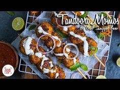 chicken skewers with sauce and garnish on a cooling rack next to a bowl of dipping sauce