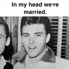 two young men are posing for the camera in black and white, one is wearing a tie