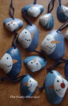 snowmen painted on rocks with string attached to them