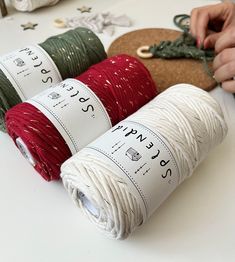 three spools of thread are sitting next to each other on a white table