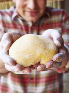 a man holding a piece of bread in his hands