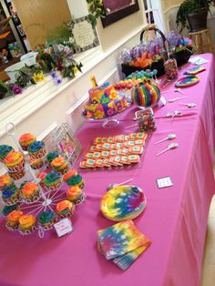 the table is set up with cupcakes and candy