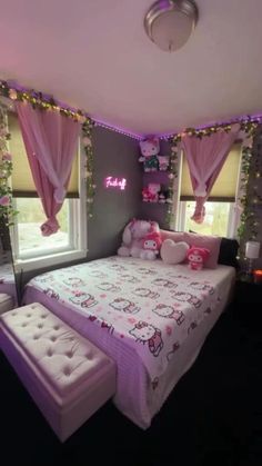 a bedroom decorated in pink and purple with hello kitty decorations on the walls, windows, and bed