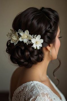 a woman wearing a wedding hair comb with flowers on it's head and pearls in her hair